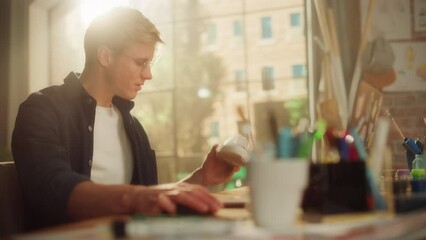 Poster - Male Artist Examining Shoes while Creating Design for it. Hipster Male is Customising Shoes by his Own Ideas, Looking at 3d Model on Laptop. Art and Small Business Concept. Dynamic Moving Art Shot