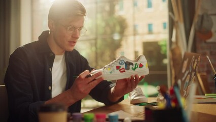 Aufkleber - Talented Artist In Creative Process Working on Design of Footwear. Man Finishing Work on a Pair of Shoes of his NFT Project. New Generation Millennial People Concept