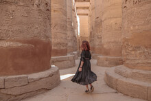 Woman Between The Pillars In The Temple Of Karnak In Luxor.