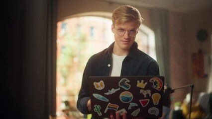 Poster - Stylish Person Using Laptop Computer with Diverse LGBTQ+ Stickers while Standing at Loft Studio. Creative Young Man Browsing Internet and Managing Social Media. Slow Motion Shot