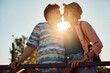 Happy lesbian couple in love touching with their noses at sunset.