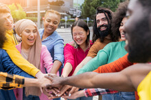 Group Of Young Friends In The Park Come Together In The Center Of A Circle To Give Unity And Strength To All - Millennials In A Moment Of Team Building - Multiracial Youth