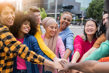 Intergenerational and multiethnic family - group of people joining hands together - concept of trust, self-esteem and collaboration between diverse people