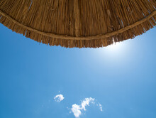 Beach Straw Umbrella And Blue Sky. Summer. Bottom View