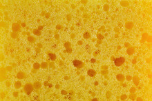Dishwashing Sponge Texture Close Up Photo. Yellow Sponge Pattern Macro Photography.