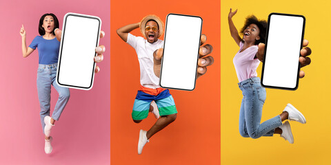 Positive millennials jumping with cell phones with empty screens