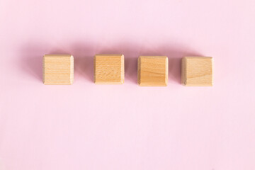 Wall Mural - Wooden cubes on yellow-pink background