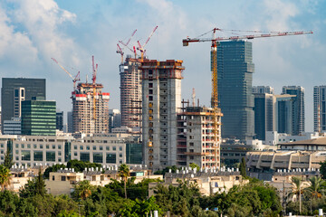 tel aviv's skyline high rise construction with cranes and water heaters, israel. a tall building in 