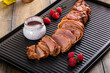 Bacon wrapped pork tenderloin with raspberry vinaigrette