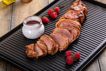 Bacon wrapped pork tenderloin with raspberry vinaigrette