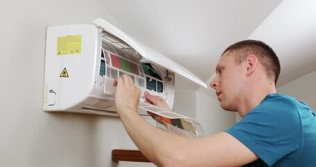 Wall Mural - Male technician cleaning air conditioner indoors