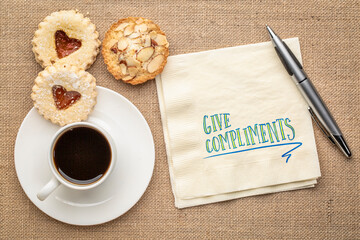 Poster - give compliments inspirational reminder or advice, handwriting on napkin with coffee and cookies, kindness, positivity  and personal development concept