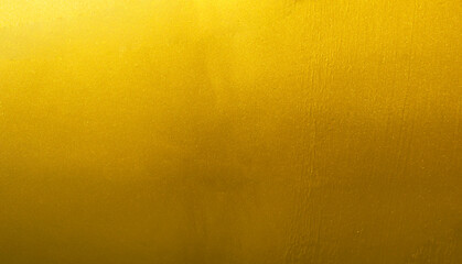 Wall Mural - Gold wall texture background. Yellow shiny gold foil paint on wall sheet with gloss light reflection