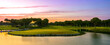 Sunset at the golf course. Scenic panoramic view of golf fairway