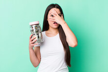 Young Adult Woman Looking Shocked, Scared Or Terrified, Covering Face With Hand. Savings Concept