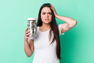 Wall Mural - young adult woman feeling stressed, anxious or scared, with hands on head. savings concept