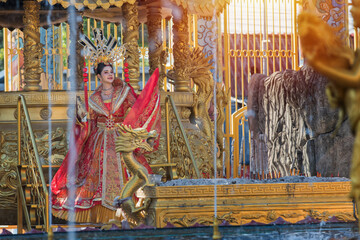 Portrait of a woman. portrait of a woman. person in traditional costume. woman in traditional costume. Beautiful young woman in a bright red dress and a crown of Chinese Queen posing. 