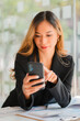© ArLawKa - Asian businesswoman or accountant working with laptop and mobile phone. Smile and be happy while sitting at your desk with your financial documents. Vertical modern shape office calculator