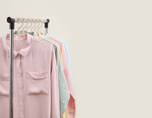 Pastel Shirts Hanging On Rack In Shop And Freespace For Text