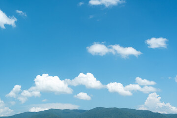 Wall Mural - the white clouds have a strange shape and moutain.the sky and the open space have mountains below.