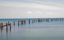 A Wide Fine Art Minimalist Image Of Swanage Old Pier Posts In A Long Exposure Still Sea