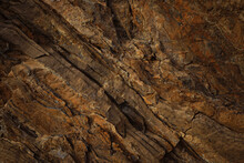 Brown Rock Texture With Cracks. Rough Mountain Surface. Close-up. Stone Background For Design.