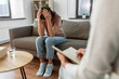 © Syda Productions - psychology, mental health and people concept - stressed young woman patient and psychologist at psychotherapy session