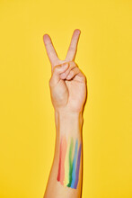 Vibrant Shot Of Arm With Rainbow Flag Tattoo And V Symbol For Pride Month LGBTQ