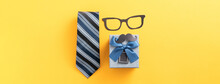 Father's Day Gift Design Concept With Gift Box And Necktie On Yellow Background.