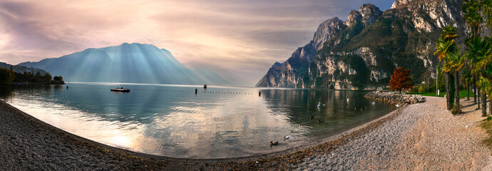 Wall Mural - Garda lake. Beautiful morning light in amazing Lago di Garda. Riva del Garda, northern Italy