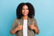 Photo of cheerful pretty lady toothy smile show two thumbs up look camera isolated on blue color background