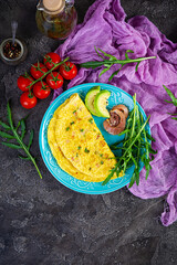 Wall Mural - Fried omelette with ham, onion and herbs. Breakfast with scrambled eggs