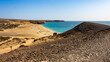 View from hillside over Playa Mujeres, Playa Blanca, Yaiza, Lanzarote, Las Palmas, Islas Canarias, Spain, Europe. Golden sand washed by the clear turquoise waters of the Atlantic Ocean.