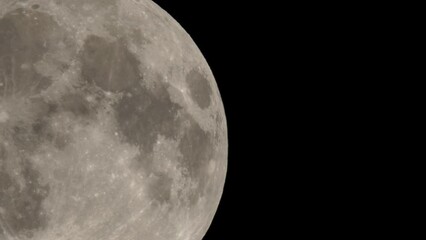 Wall Mural - Full moon on dark black sky background, shot from surface of earth with very long telephoto lens. Grey white moon glowing at clear sky.