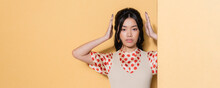 Fashionable Asian Model In Retro Clothes Posing On Orange Background, Banner.