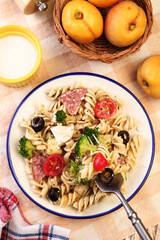 Wall Mural - Pasta salad with tomatoes, ham, black olives, broccoli and cheese