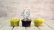 Happy birthday muffins with candles with the number 49. Card copy space with pies for congratulations.