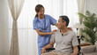 © PR Image Factory - Asian female nurse and male senior wheelchair user enjoying chatting by the window at home. in-home social care for elderly disabled people concept