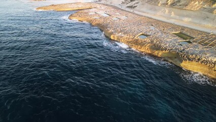 Wall Mural - Aerial view of Salt Pans in Gozo, Xwejni Bay at sunset