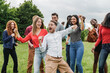 © Vane Nunes - Multiethnic group of friends having fun dancing together outdoor during summer vacations - Focus on center man face