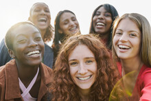 Multiethnic Young Women Having Fun Together Doing Selfie Outdoor - Focus On Ginger Hair Girl Face - Diversity Lifestyle Concept
