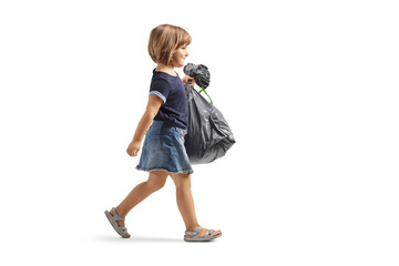 Poster - Full length profile shot of a little girl walking and carrying a waste bag