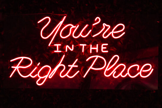 Photograph of a red neon sign on which the word 