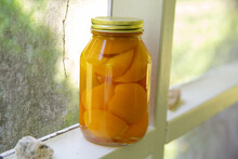 Jar Of Pickled Peaches On Porch