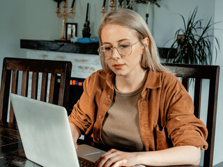 woman developer coding on laptop computer. front view
