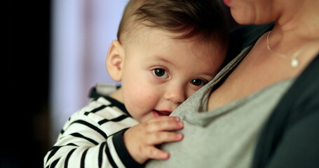 Canvas Print - Happy smiling baby in mother arms. Parent holding adorable cute child smile