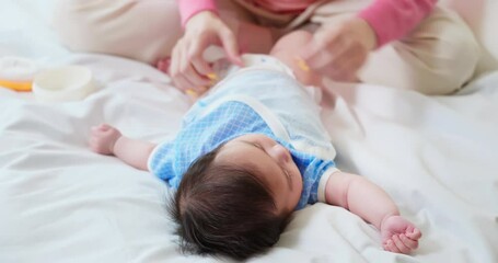 Wall Mural - Mother changing baby diaper