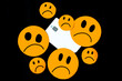 illustration of discontent, scam, disappointment with bank credit cards represented with sad orange emoticons and a bank card on a black background