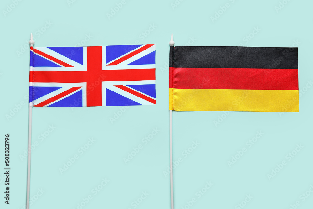 Flags of Germany and Great Britain on color background, closeup