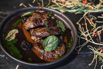 Veal cheeks in red wine with blackberries and demiglace sauce